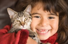 Young girl with gray cat